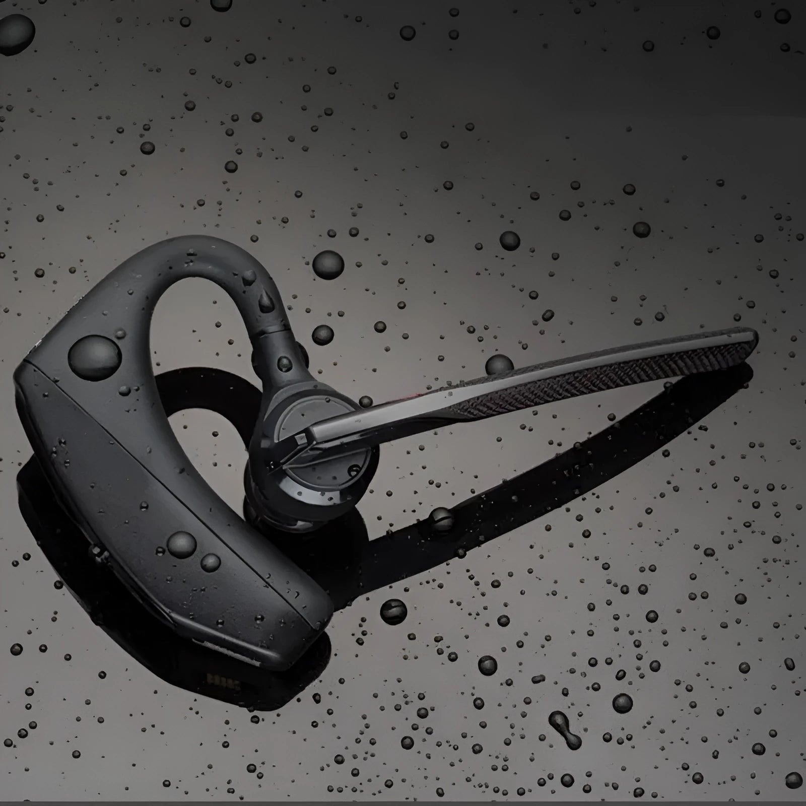 Black stereo Bluetooth sports headphones with a simple plastic design on a white background.