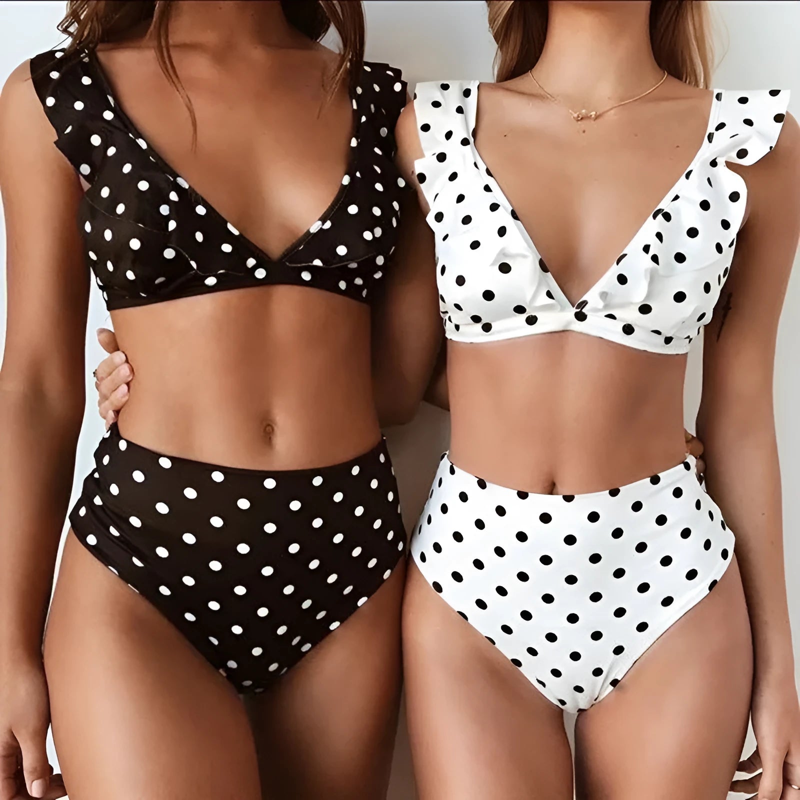 Black and white polka dot women's bikini set with a deep V-neck top and ruffled trim.