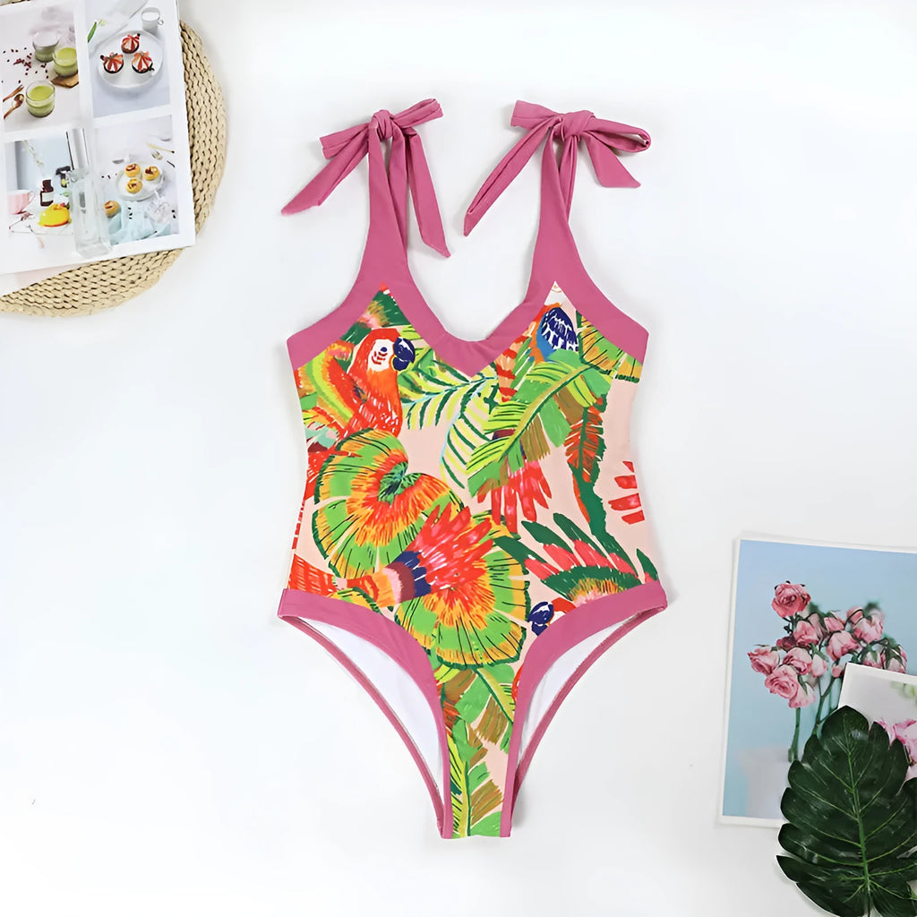 Retro pink floral print one-piece swimsuit with V-neck, skirt, and backless design.