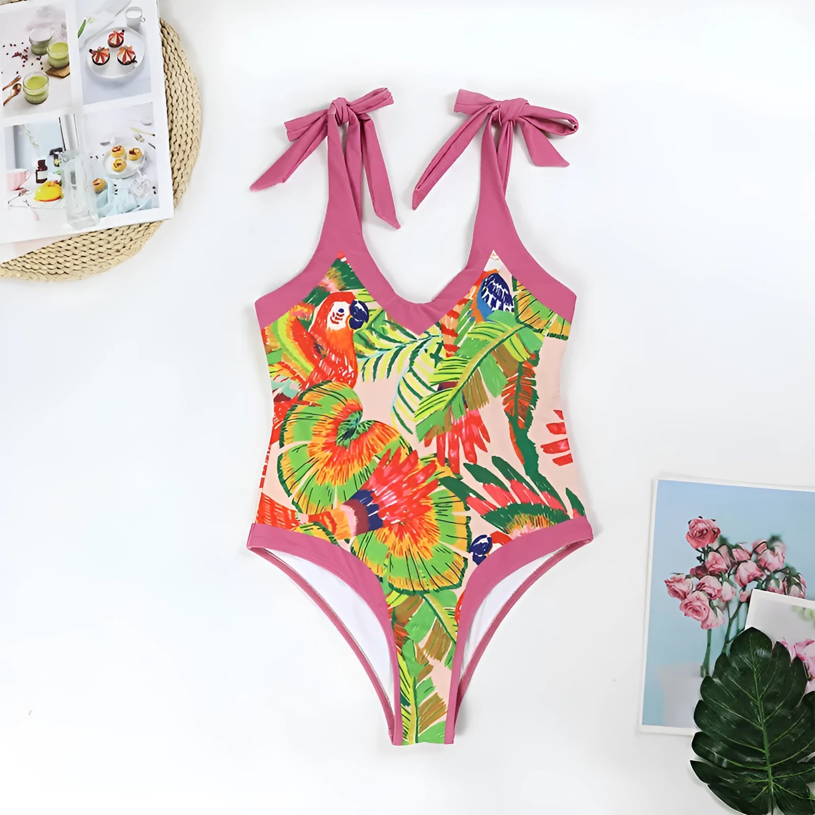 Retro pink floral print one-piece swimsuit with V-neck, skirt, and backless design.