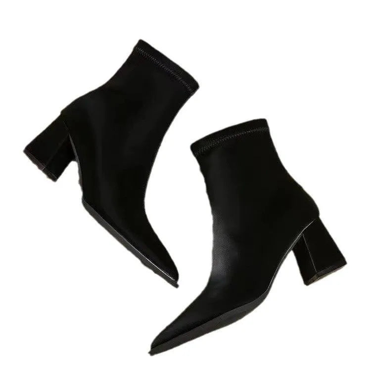 Women's khaki pointed-toe Martin boots with a wedge heel on a plain background.