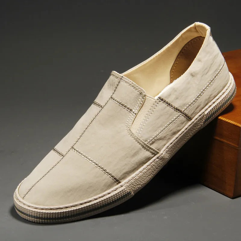 Men's low-top slip-on canvas shoes in various colours showing round toe and vulcanised rubber sole.