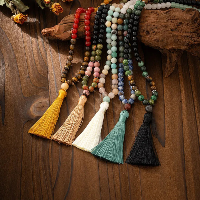 Vintage bohemian long necklace with tassel and stone beading alongside matching bracelet in geometric ball bead design