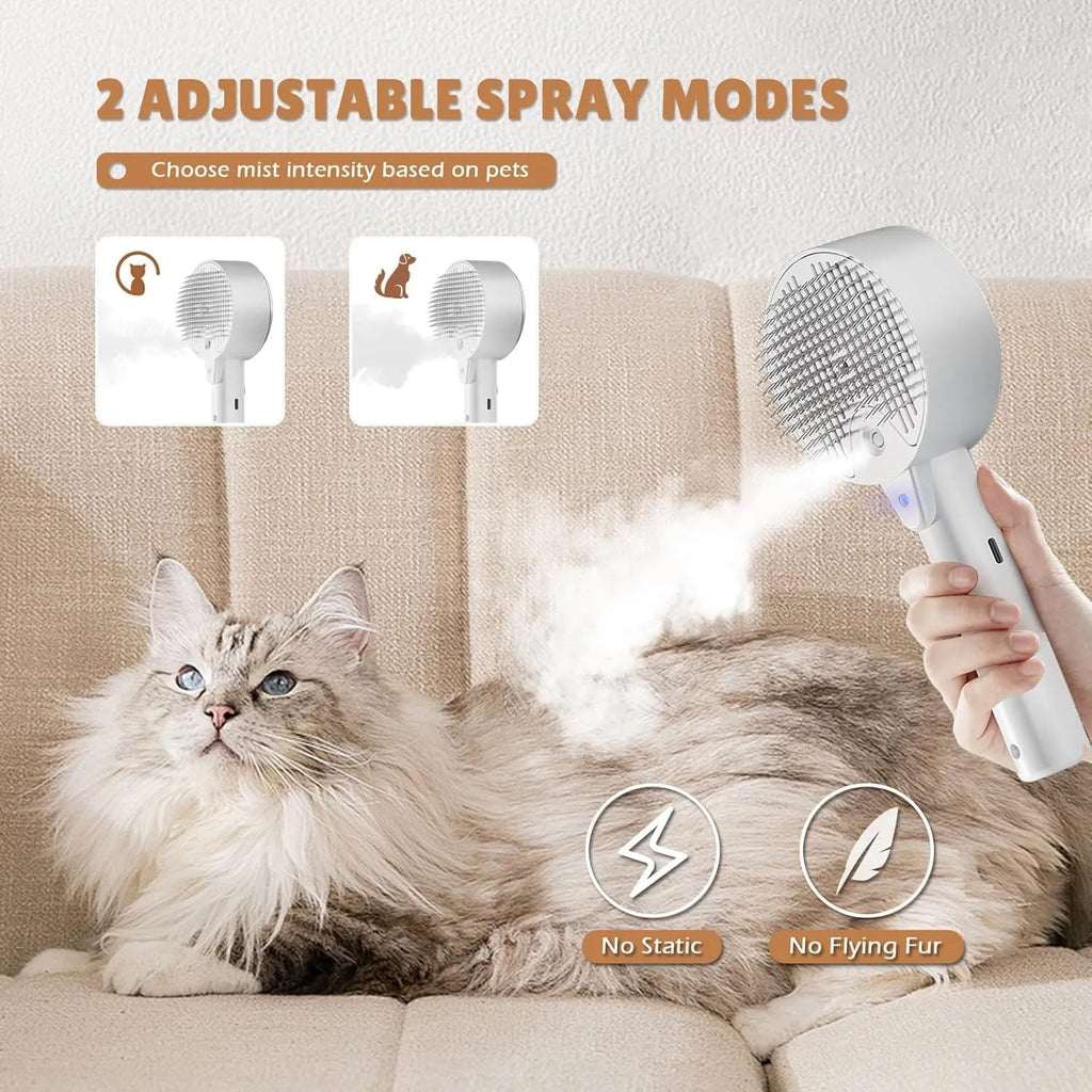 Pink and white cat steam brush with spray tank, stainless steel bent bristles, and a one-click hair removal button.