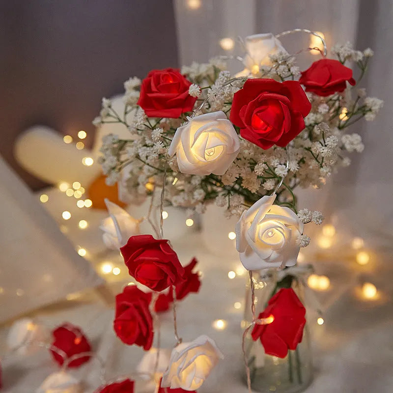 Battery-powered LED fairy lights with ten pink PV foam roses on a 1.5-metre wire for indoor decoration.