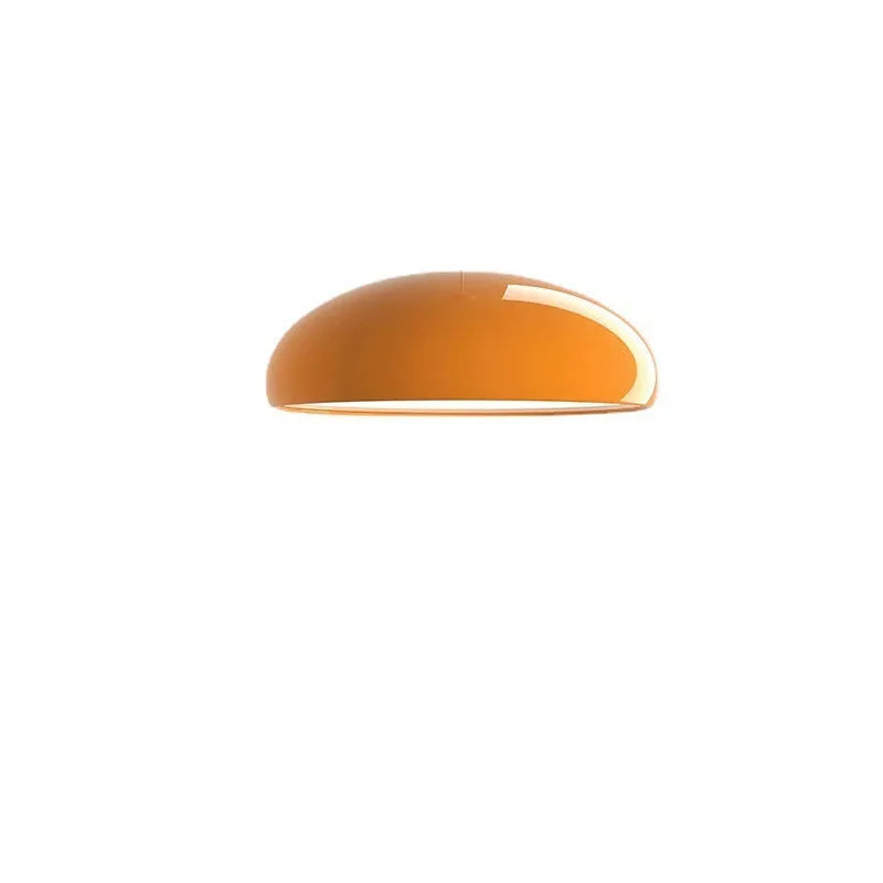 Danish-style iron pendant lamp with adjustable cord above a restaurant table.