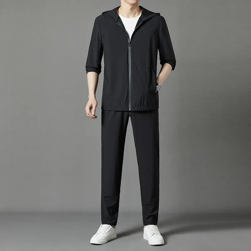Grey hooded sun-protective top and trousers casual set laid flat showing loose fit and pocket detail