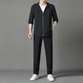 Grey hooded sun-protective top and trousers casual set laid flat showing loose fit and pocket detail
