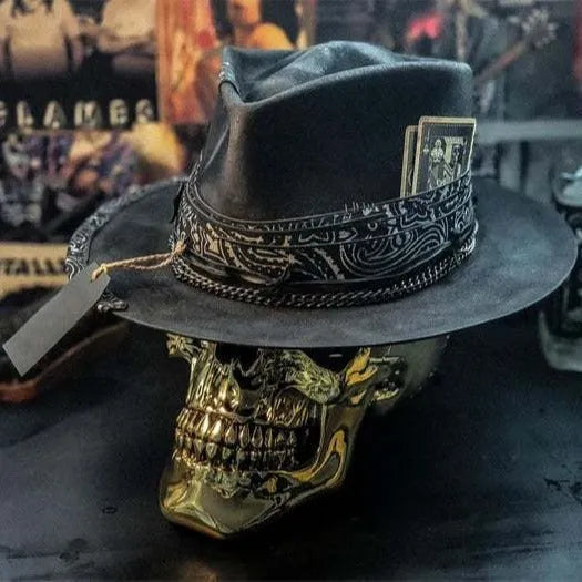 Handmade black and white skull print pointed witch hat on a wooden surface
