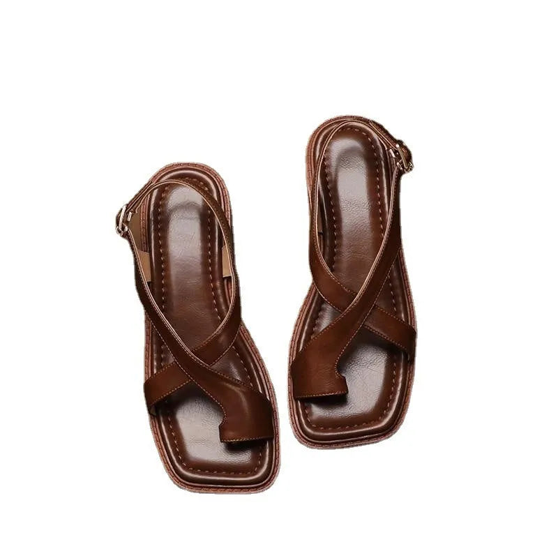 French retro brown toe ring sandals with square toe and ankle-strap buckle on a neutral background
