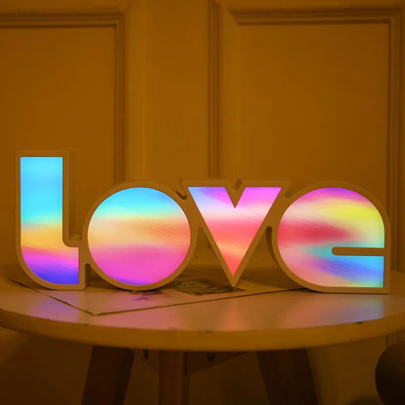 Rainbow halo style LED LOVE decorative light measuring 35.5cm wide