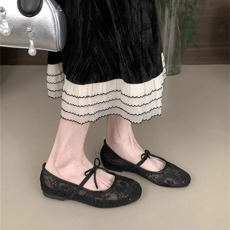 Women's pink flat lace mesh Mary Jane evening shoes with a mid heel on a white background.