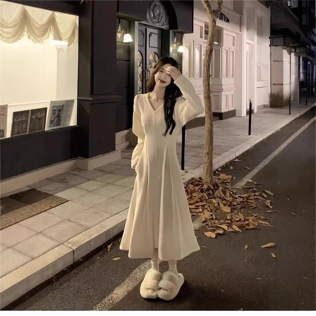 Women's long sleeveless V-neck knitted dress in milky white with a suspender skirt design.