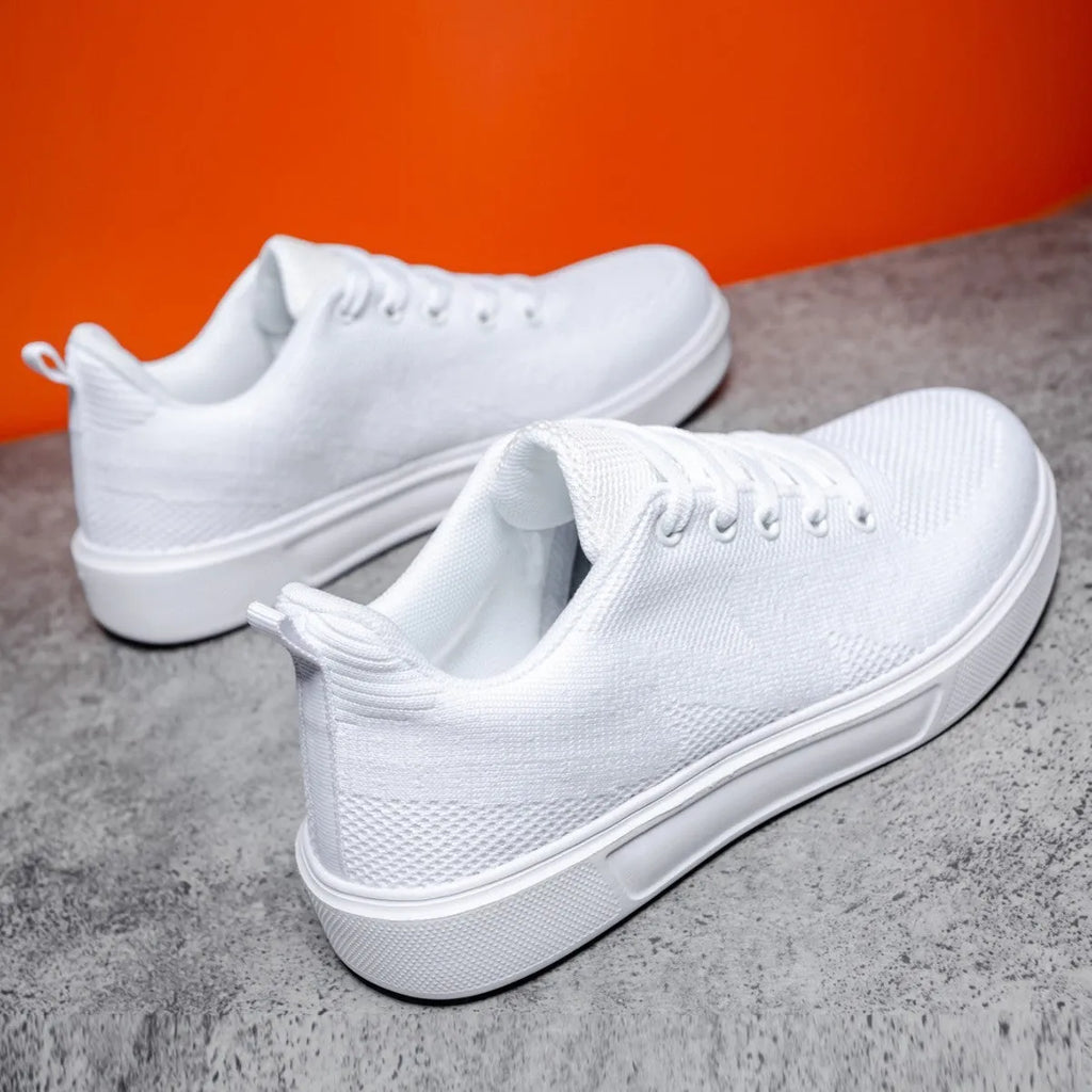 White casual sports shoes with thick EVA sole and mesh upper, flat heel, round toe, front lace-up closure