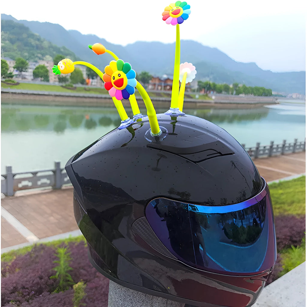 Yellow sunflower silicone decoration with a suction cup base for attaching to a helmet.