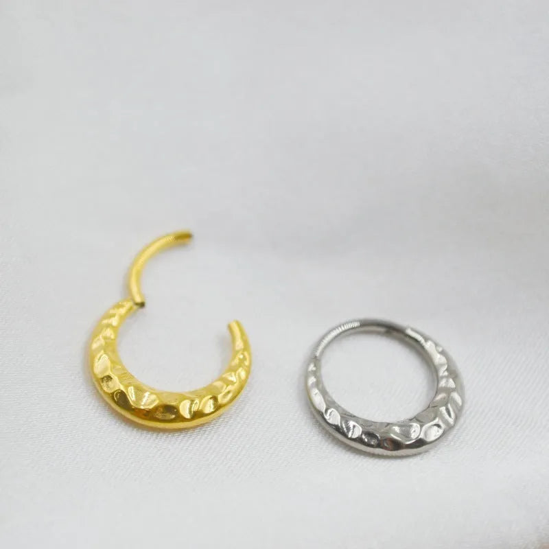 Titanium alloy ASTM F136 concave-convex nose ring in gold and silver colour options showing textured surface detail