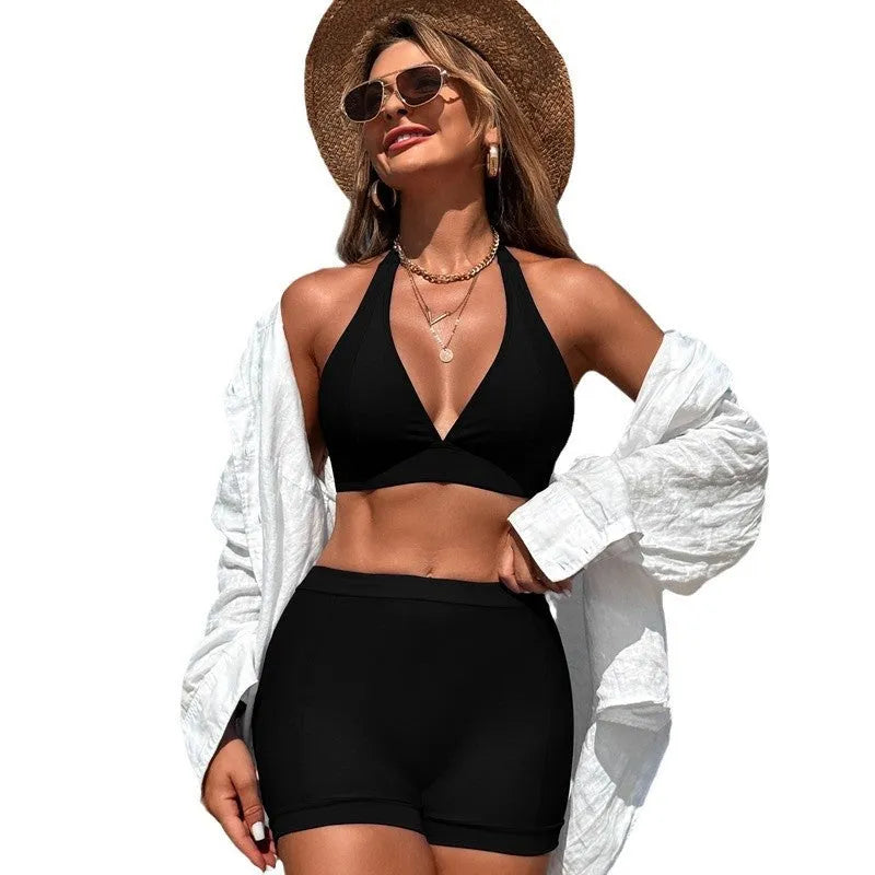 Women's black bikini swimsuit laid flat, showing the two-piece sleeveless design.
