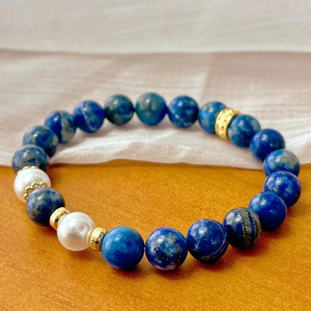 Chinese-style artistic retro lapis lazuli bracelet with green and gold stone on a white background.