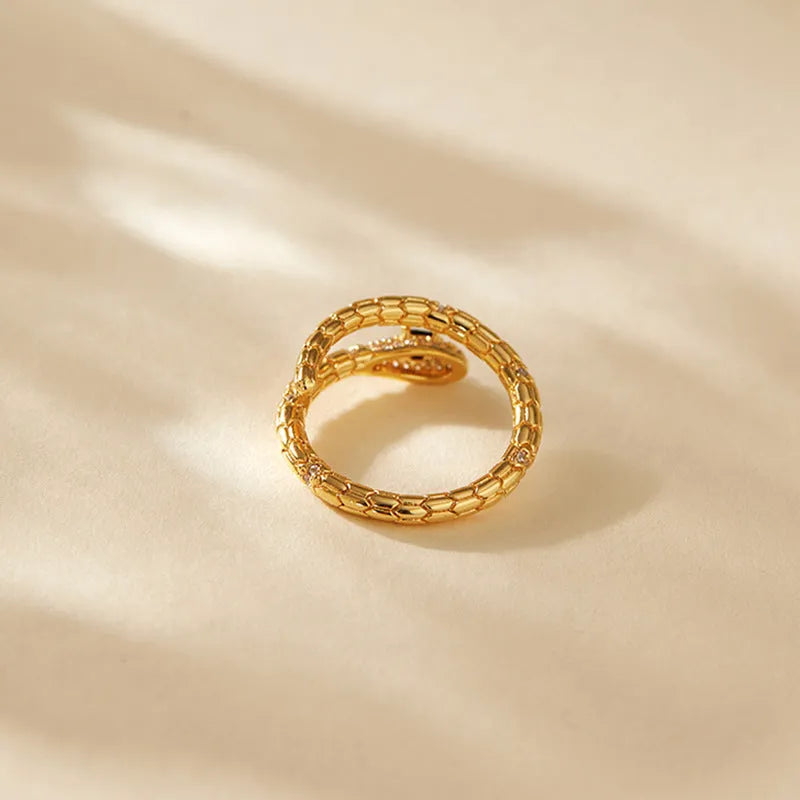 Copper snake ring with adjustable opening and gold colour plating, showing open mouth design