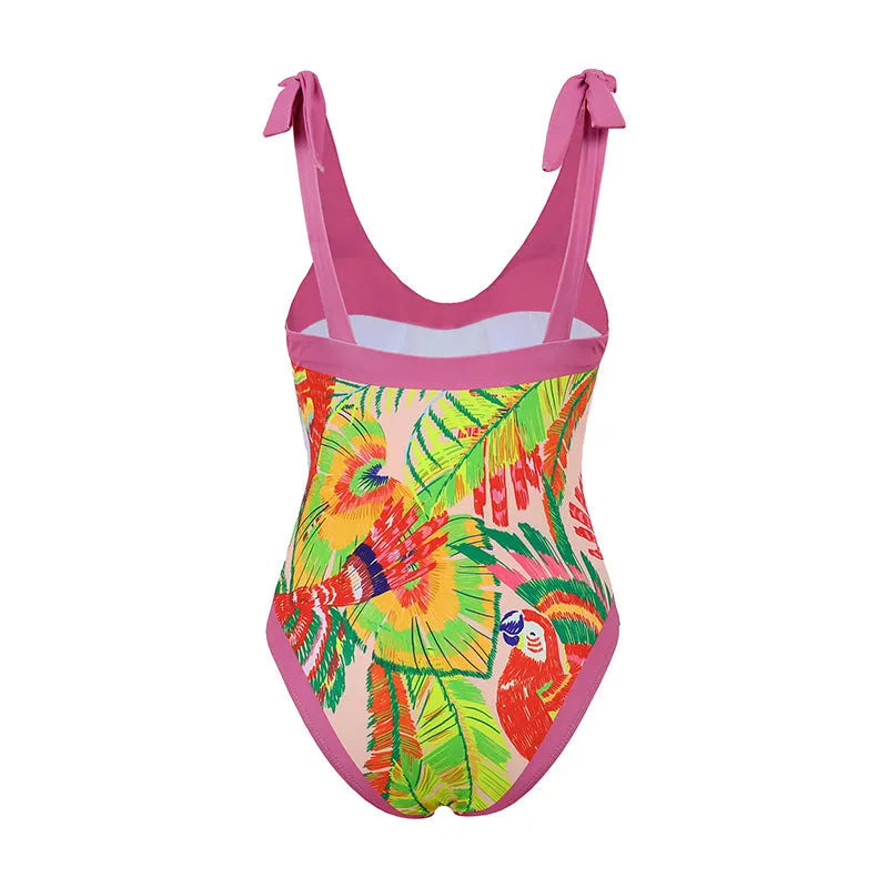Retro pink floral print one-piece swimsuit with V-neck, skirt, and backless design.