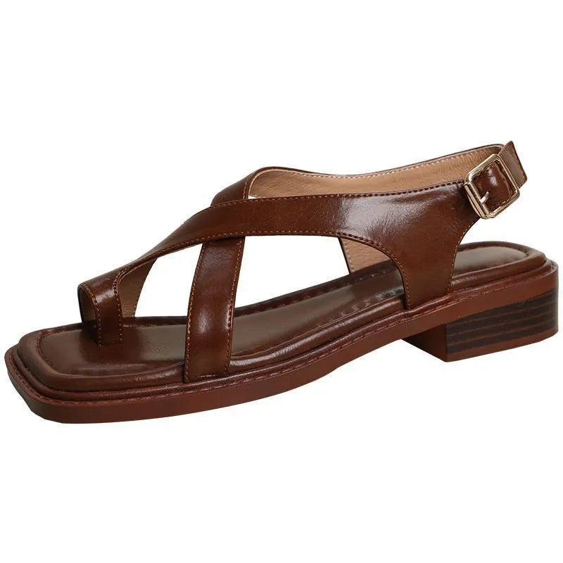 French retro brown toe ring sandals with square toe and ankle-strap buckle on a neutral background