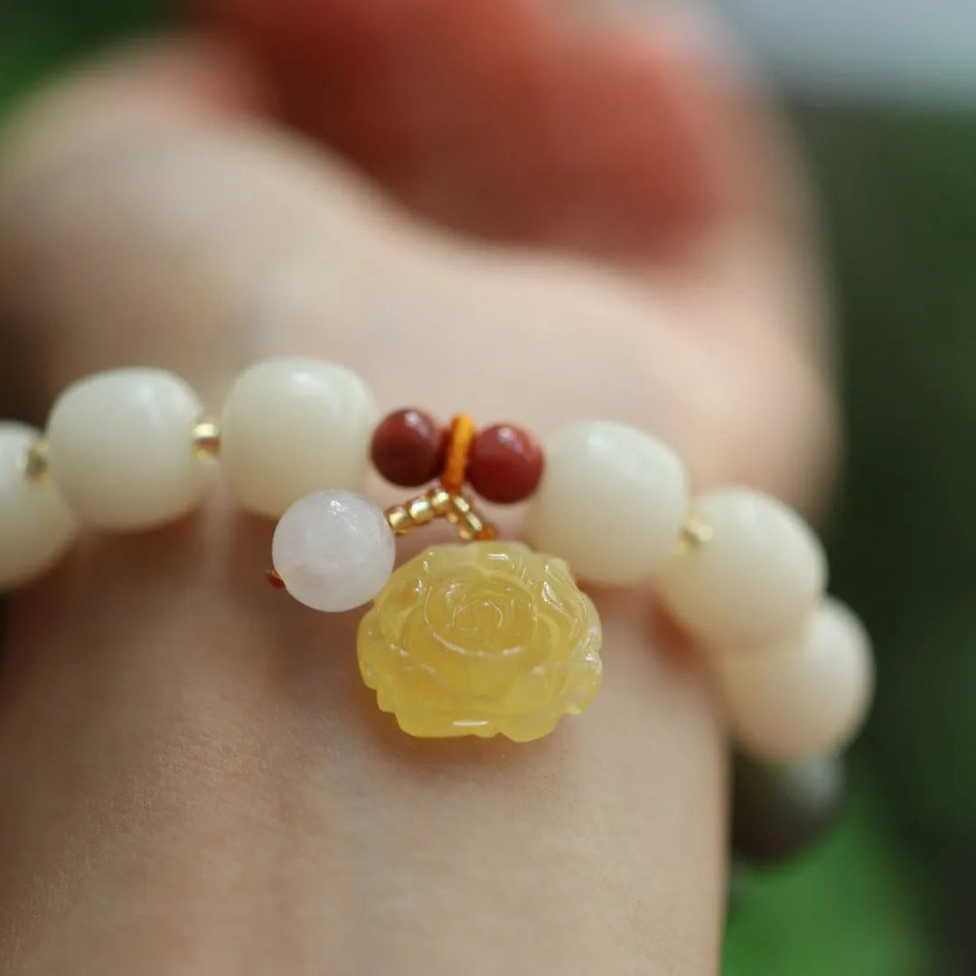Women's handwoven bracelet with gradient White Jade beads and beeswax Lotus pendant on Bodhi root