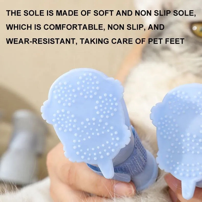 Four waterproof silicone dog rain boots in blue, grey, light blue and pink on a white background