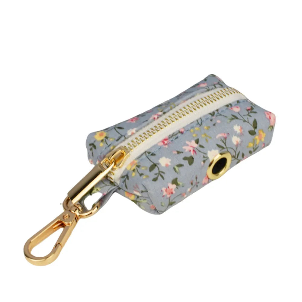Blue floral cloth dog collar and leash set with bow and vest accessories on a size chart from XS to XL.