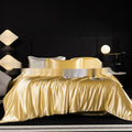 Silk four-piece bed sheet set in a solid colour on a bed, showing modern simplicity style.