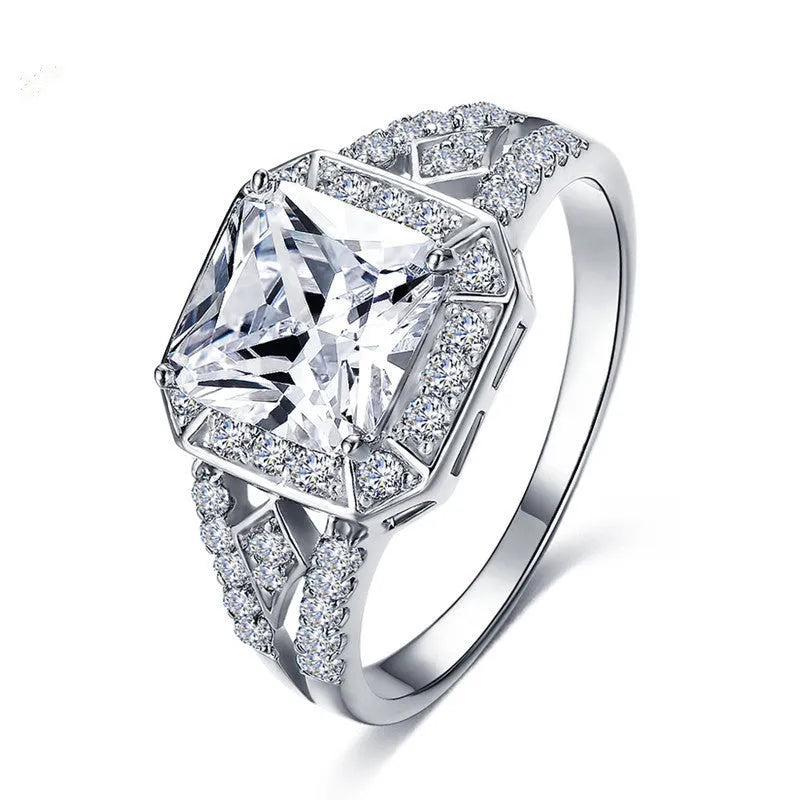 Platinum colour geometric women's ring with hollow design and inlaid zircon stone.