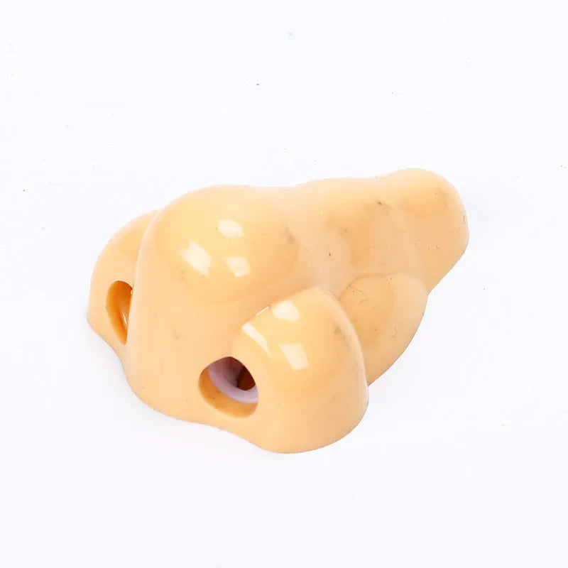 Geometry plastic pencil sharpener with big nostril opening in flesh colour measuring 58x45x30mm