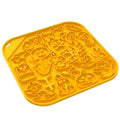 Silicone dog slow feeder bowl in a hexagonal shape on a floor, showing textured surface for slowing eating pace.