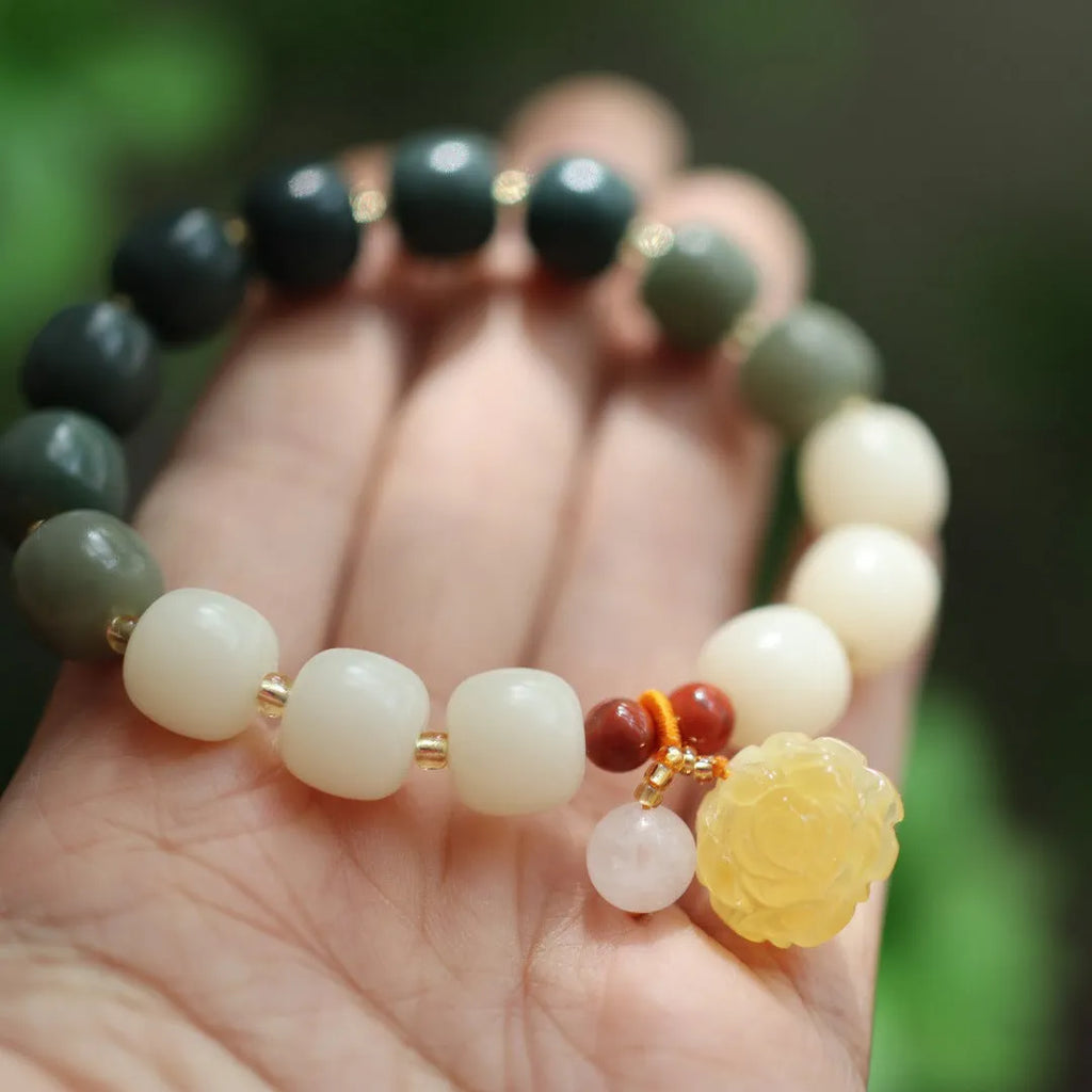 Women's handwoven bracelet with gradient White Jade beads and beeswax Lotus pendant on Bodhi root