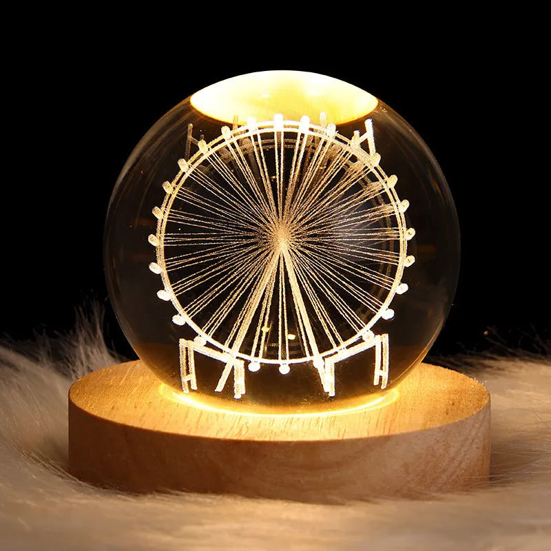 LED galaxy crystal ball night light with 3D planet designs on a table