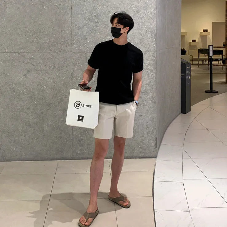 Men's straight-leg casual shorts in solid black colour, laid flat to show loose fit.