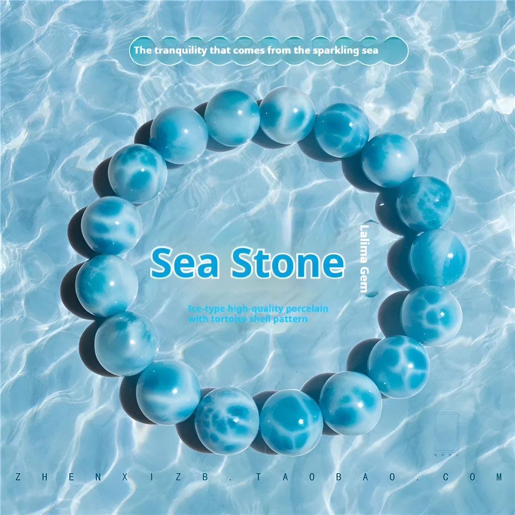 Blue Bodhi bead bracelet with white pearl accents on a plain background.