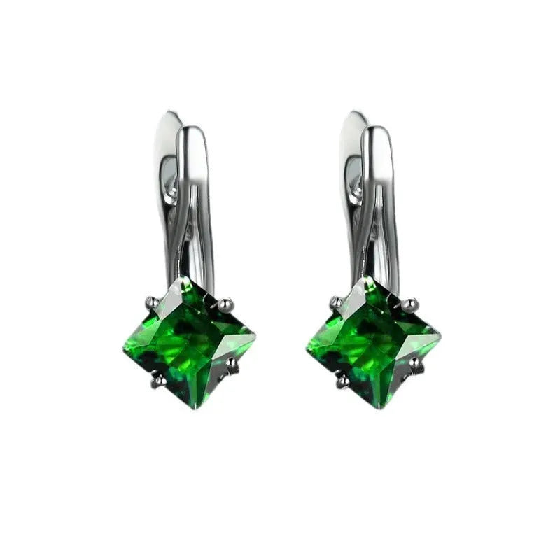 A pair of women's copper earrings with a simple diamond design and inlaid zircon stones, shown in blue.