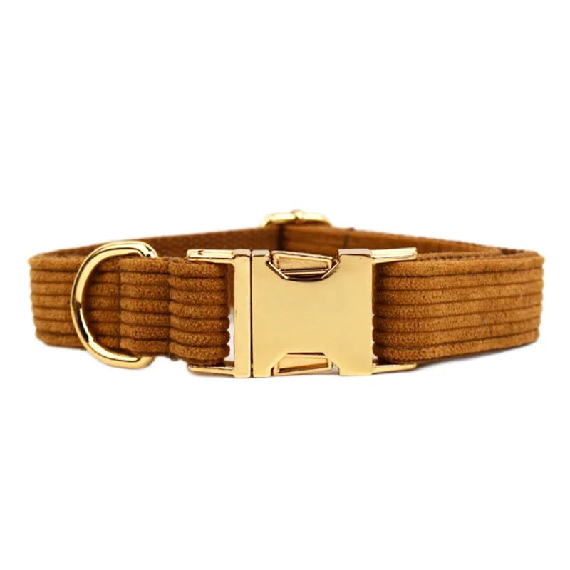 Caramel corduroy five-piece pet collar set with bow, vest, and poop bag on a dog