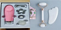 White jade facial roller set with double-headed roller claw and scraping board on wooden surface