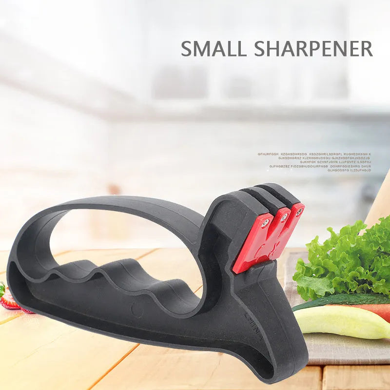 Black handheld knife and scissor sharpener with tungsten steel blade on white background
