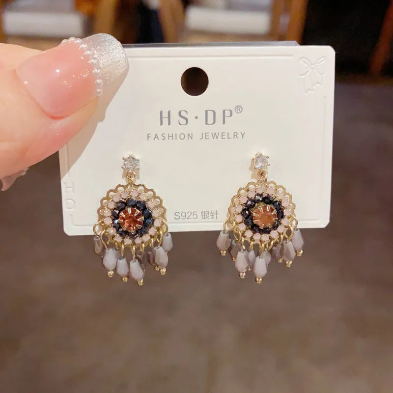 Round crystal tassel earrings with diamond embedded design in thick gold plated copper