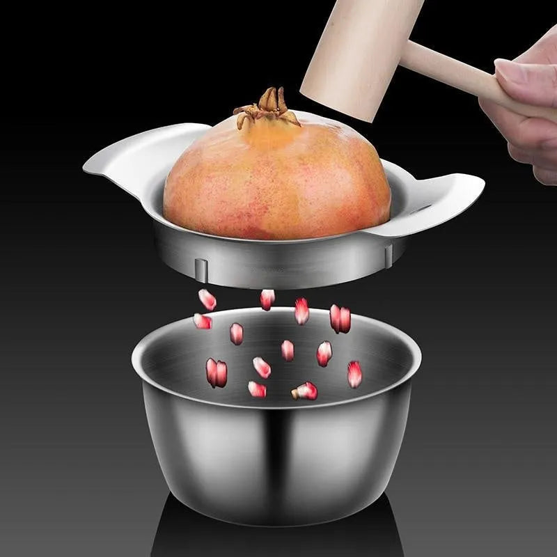 Stainless steel pomegranate fruit cutting tool set with bowl and wooden hammer on a kitchen counter