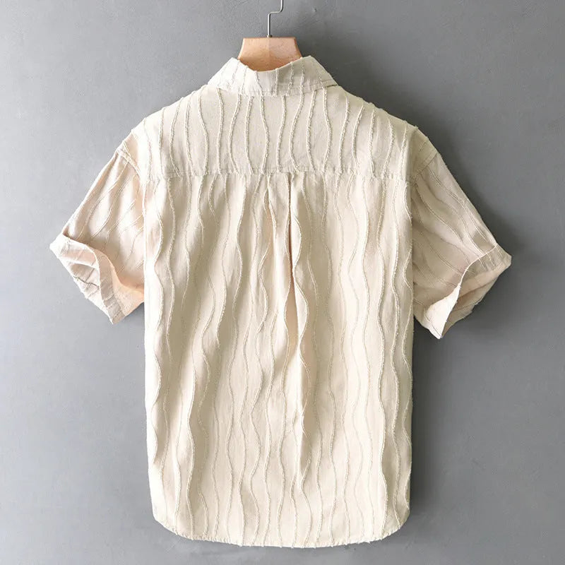 Man wearing a loose-fit apricot pure cotton short sleeve casual shirt with a Japanese fresh style.