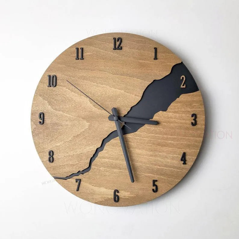 Modern wooden wall clock with a cracked surface design on a plain wall.