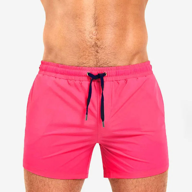 Pair of solid colour sports shorts with mesh lining for swimming and fitness training.