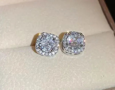 A pair of square geometric diamond-treated alloy earrings on a silver or gold background.