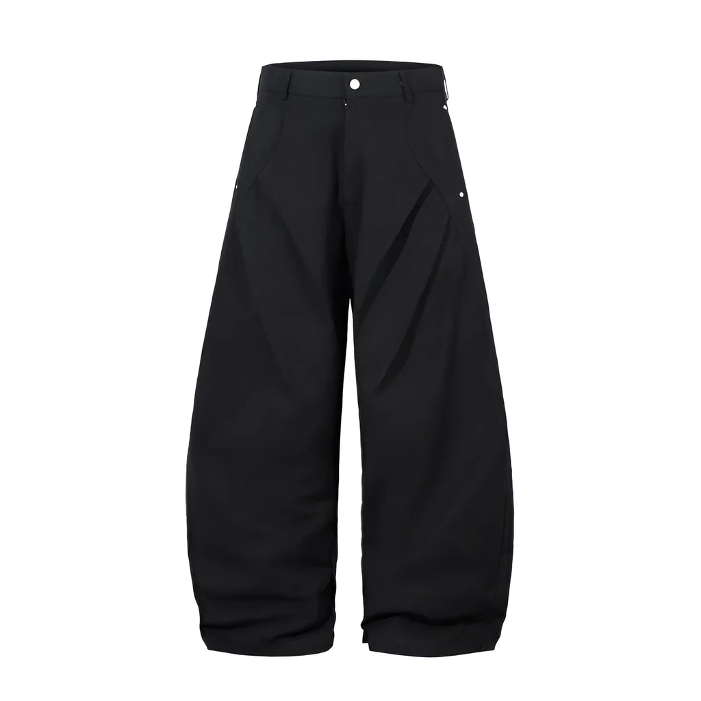 Man wearing black pleated wide-leg casual cotton trousers in a loose fit.