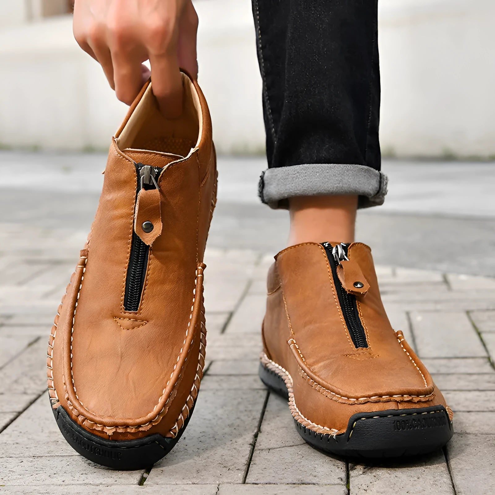 Men's black slip-on leather loafers with a round toe and low flat heel on a rubber sole.