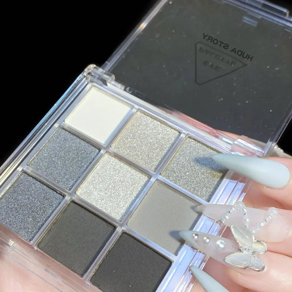 Smoked nine-colour eye shadow palette showing white, silver, black, and iron grey shades.