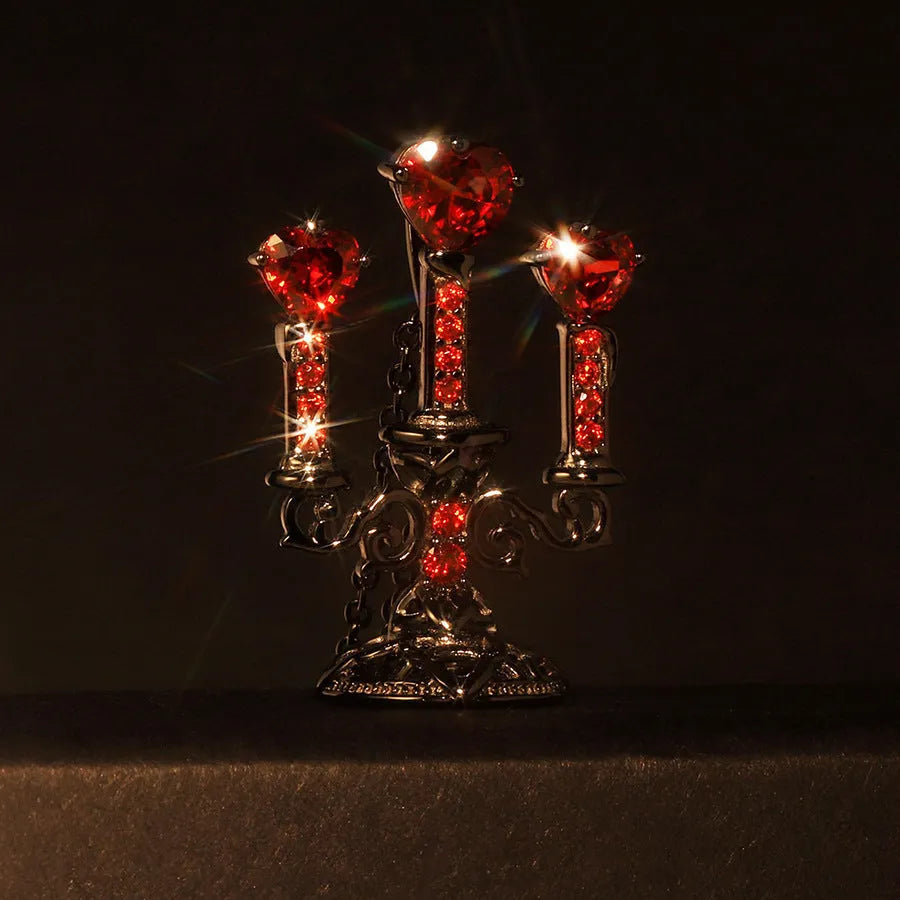 Close-up of a women's retro gothic necklace with a hollow candlestick pendant on a cross chain.